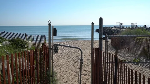 STATIC SHOT OF GATE TO DOG BEACH, LAKE IN BACKGROUND Stock Footage 106140339