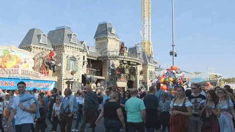 Static shot, of a ghost train, In the foreground, many people walk by and Stock Footage 102073696