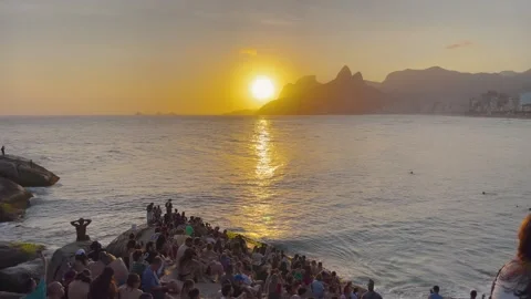 Static Shot Golden Sunset Crowd at Pedra do Arpoador Rio de Janeiro Stock Footage 334330075