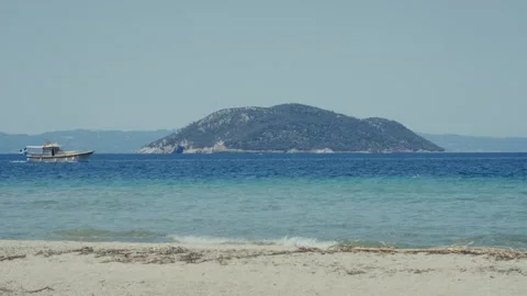Static Shot of a Greek Beach, Turquoise Sea, and Island in Halkidiki Stock Footage 321668265