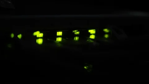 Static shot, of a green lights blinking, in the dark, on a internet modem, Stock Footage 105271392