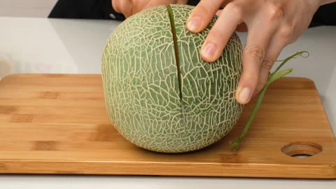 Static Shot Of Halved Green Netted Melon Cantaloupe With Orange Flesh 4K Stock Footage 323082557