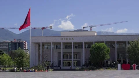 Static shot of the iconic opera house facade on Skanderbeg Square under a blue Stock Footage 336569120
