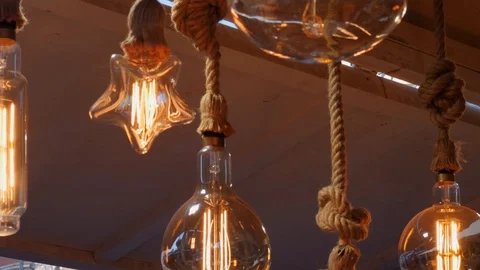 Static shot of lanterns hanging, tied with rope. Nice orange light. Stock Footage 121762677