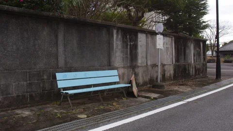 Static Shot of a Light Blue Bench at a Rural Japanese Bus Stop Stock Footage 336565798