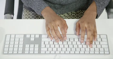 A static shot looking down at a ladies hands whilst she is typing on a keyboa 動画素材 88488018