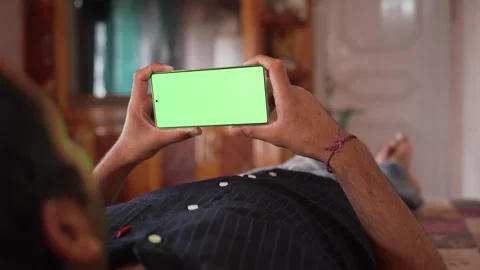 Static Shot of Man Lying Down at Home Holding Smartphone. Stock Footage 338299455