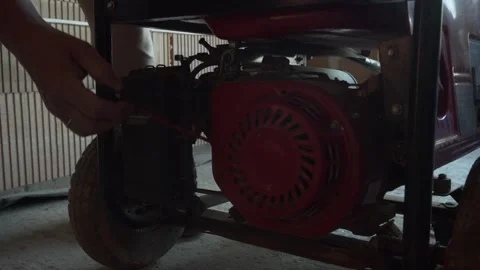 Static shot of man starting old gasoline generator on construction site. Stock Footage 255022858