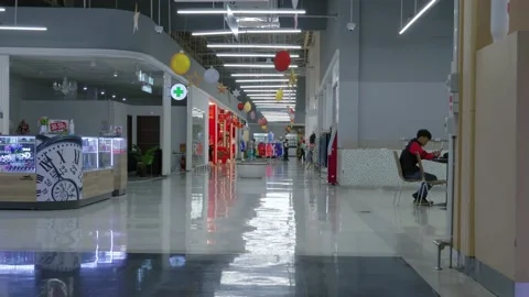 Static shot of a man texting while sitting on a table inside a Lotus Stock Footage 237493727