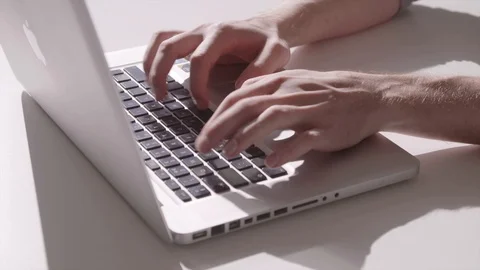 Static shot of a man typing on the keyboard of a laptop Stock Footage 92525478