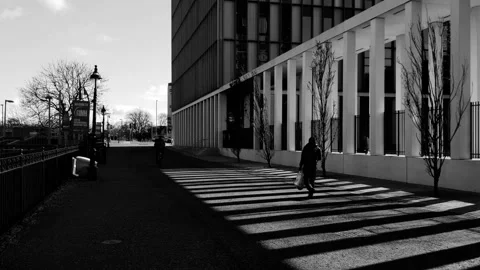 Static shot of man walking through bars of light Video stock 171801400