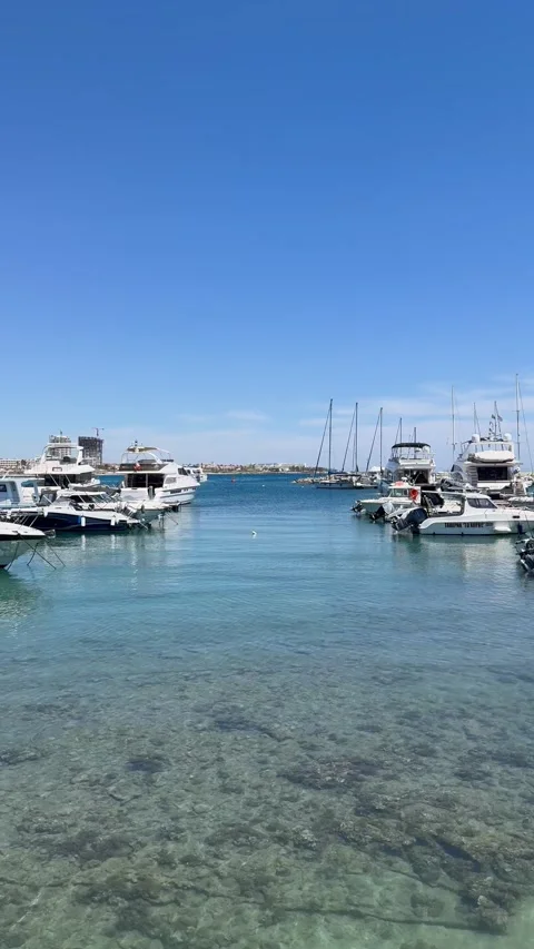 Static shot of a marine harbor channel with boats anchored on both sides Stock Footage 336278770