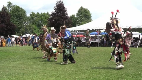 Static shot of men dancing at an outdoor pow wow Stock Footage 246398194