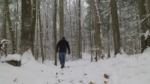 Static shot of a middle-aged man wearing blue jeans a black jacket and boots Stock Footage 329461377