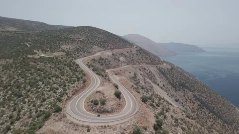 Static shot of motorcycle riding through winding road in Lesbos, Greece, sunny 库存影片 333023379