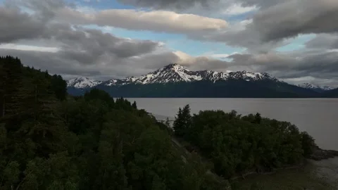 Static shot of Mountain Peak with Snow, Lots of clouds with small patches of Stock Footage 317996141