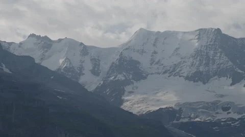 Static shot of mountains covered in snow, clouds moving Stock Footage 166616700