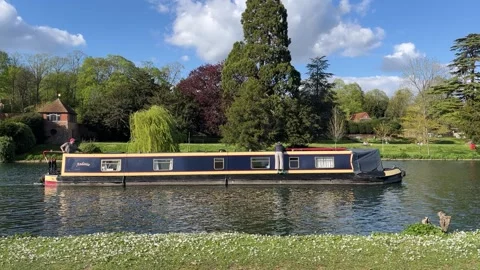 Static Shot of Narrowboat Passing on River in England Countryside Stock Footage 333229975