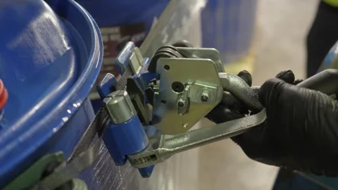 Static shot no sky industrial drum strapping tool in factory France Stock Footage 336365666