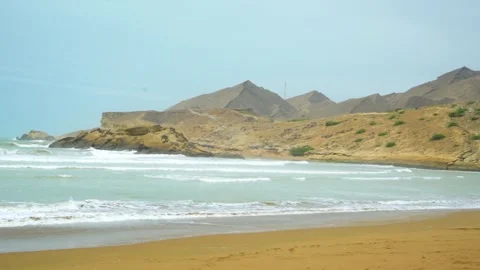 Static shot of the ocean with calm waves reaching the shore of a white sand  Stock Footage 284444573
