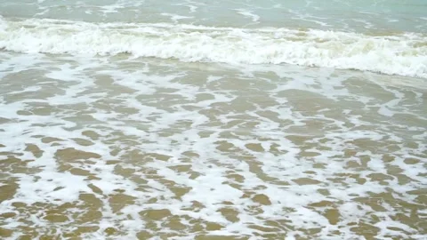 Static shot of the ocean with calm waves reaching the shore of a white sand  Stock Footage 284444752