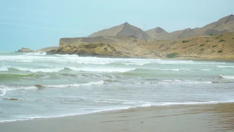 Static shot of the ocean with calm waves reaching the shore of a white sand  Stock Footage 284444969