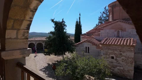 Static shot of old monastery through a stone arch 스톡 동영상 347273240