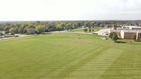 Static shot over of various school/community fields in a lawn mowing process Stock Footage 142489326