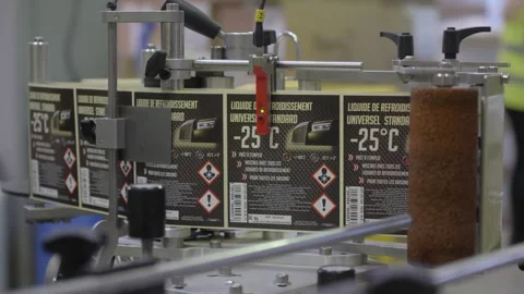 Static shot overcast factory coolant labeling line in France Stock Footage 336367466