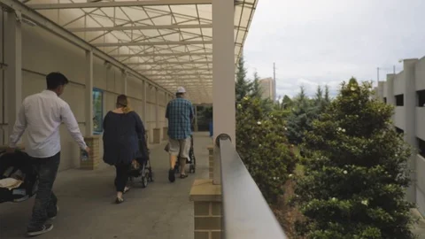 Static shot of people walking down sidewalk Stock Footage 90362380