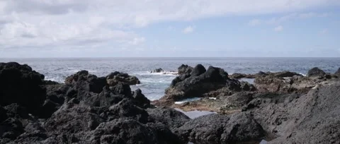 Static shot of Ponta da Ferraria a calm shot of the ocean, waves crashing Stock Footage 320074233