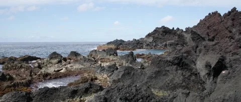 Static shot of Ponta da Ferraria a calm shot of the ocean, waves crashing Stock Footage 320074293