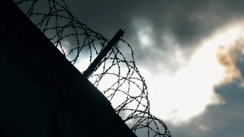 Static shot of the prison wall and barbed wire Stock Footage 303553260