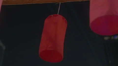 Static Shot of Red Fabric Lantern Hanging in Dark Setting 스톡 동영상 332456154