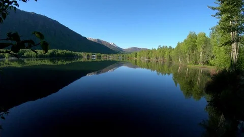 Static shot of rock being thrown into water at Mirror Lake near Anchorage Stock Footage 113647734