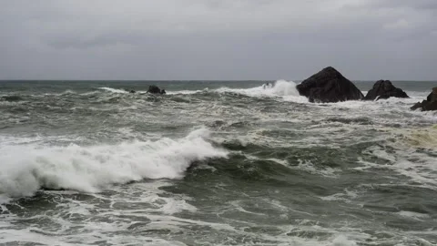 Static shot of rough and dangerous sea with large waves breaking against the Stock Footage 254861288