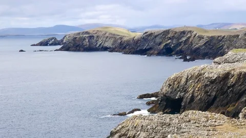 A static shot rugged coastal cliffs in Shetland Stock Footage 155536924