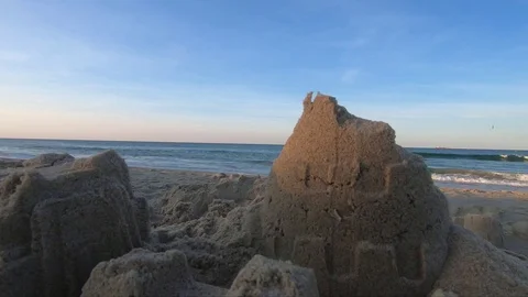 Static Shot of Sand Castle With Surf in Background Stock Footage 114890332