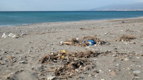 Static shot of a sandy beach  with many plastic garbage Stock Footage 121575507
