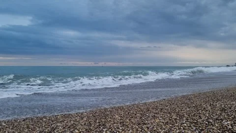 Static shot of sea waves breaking on sandy beach shore Stock Footage 320253630