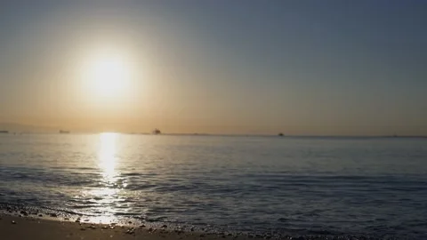 Static shot of sea waves hitting shore at sunrise Stock Footage 133261233