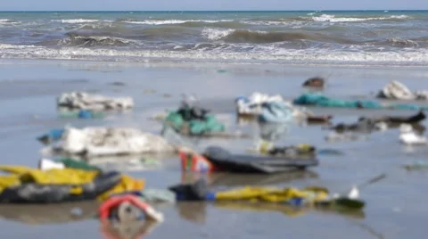 Static shot of sea,close up of plastic garbage and trash on beach in defocus Stock Footage 50787264