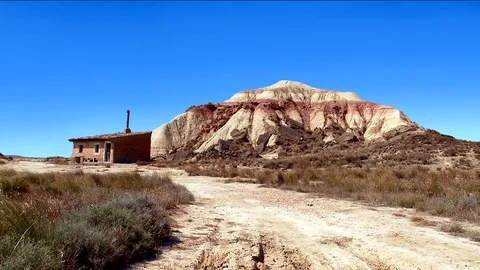 Static shot of shack and rock formations - Bardenas Riales Natural Park, Spain Stock Footage 74601483