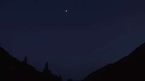 Static shot of silhouetted mountains with trees against sky at night, Montana Stock Footage 202909046