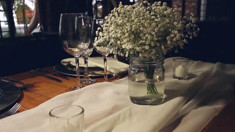 Static shot of silver and white place setting with flowers Stock Footage 160829392