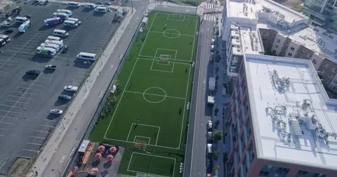 Static shot of soccer field pan down of middle of city Stock Footage 155463244