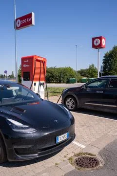 A static shot of a solid black Tesla Model 3 charging at the CircleK HPC Stock Photos