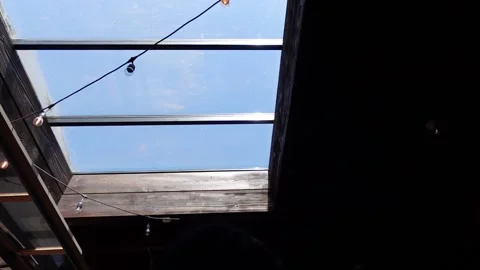 Static shot of staring up to a sky light window on a beautiful day Stock Footage 312479352