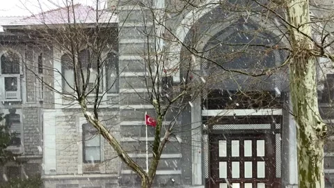 Static shot of the stone facade and wooden entrance of an Istanbul building Stock Footage 340154889