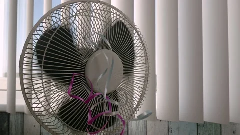 Static shot of a stopping fan in the bac... | Stock Video | Pond5